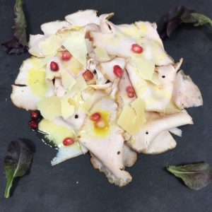 Arista di maialino con slasa al limone melograno e scaglie di grana